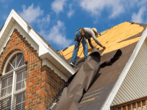 Roofing crew removing old shingles from a roof in Peachtree City, GA